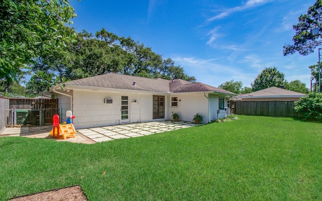 back of house with a yard, a fenced backyard, and a patio