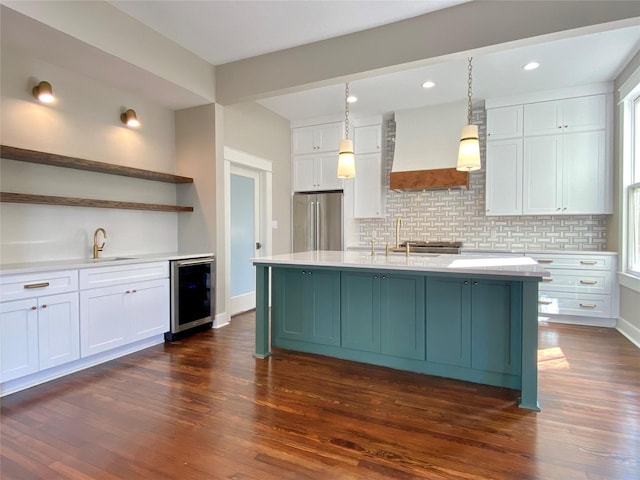 kitchen featuring open shelves, wine cooler, custom range hood, white cabinets, and high end refrigerator