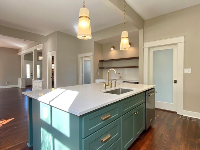 kitchen featuring green cabinets, dark wood-type flooring, decorative columns, and a sink