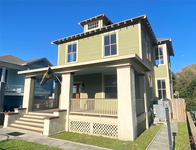 american foursquare style home featuring covered porch