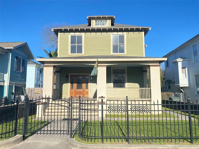 traditional style home featuring a fenced front yard, a porch, and a gate