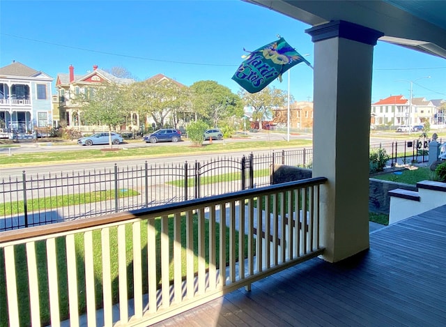 wooden deck with a residential view and fence