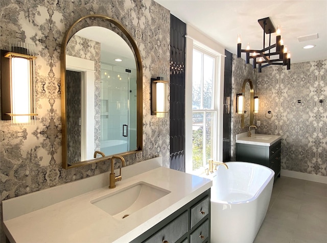 bathroom featuring a sink, a soaking tub, a shower stall, and wallpapered walls