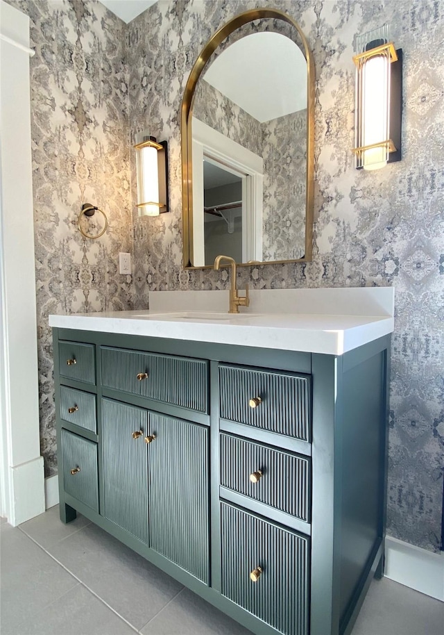 bathroom with wallpapered walls, tile patterned floors, and vanity