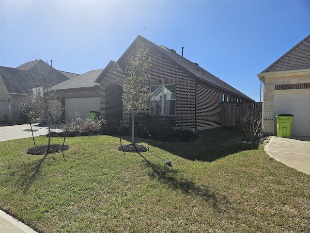 view of front of home featuring brick siding, concrete driveway, a front lawn, and a garage