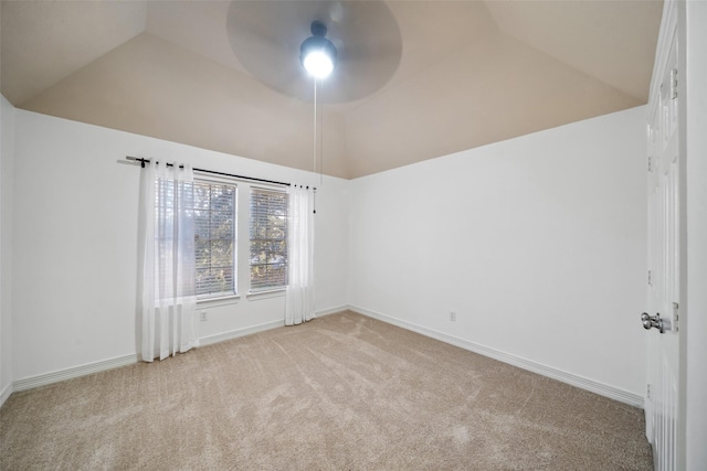 carpeted spare room with ceiling fan, baseboards, and lofted ceiling