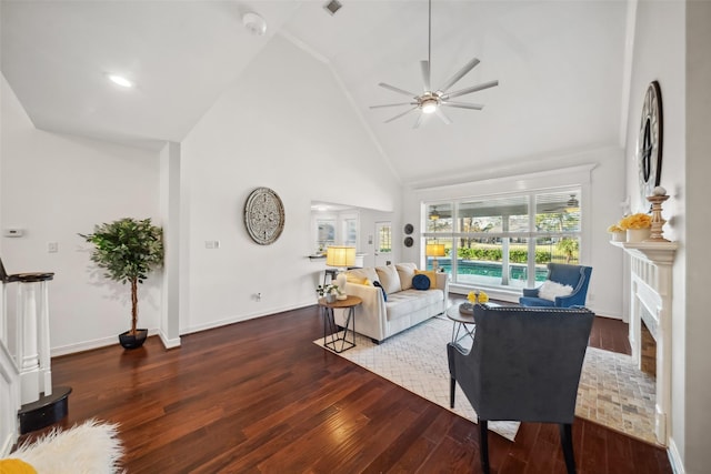 living area featuring a brick fireplace, wood finished floors, baseboards, and high vaulted ceiling