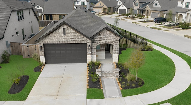 french country inspired facade featuring brick siding, fence, a residential view, concrete driveway, and a garage