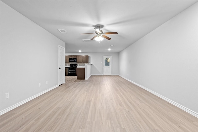 unfurnished living room featuring visible vents, light wood-style flooring, a ceiling fan, and baseboards