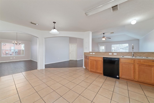 kitchen featuring visible vents, dishwasher, open floor plan, and a sink