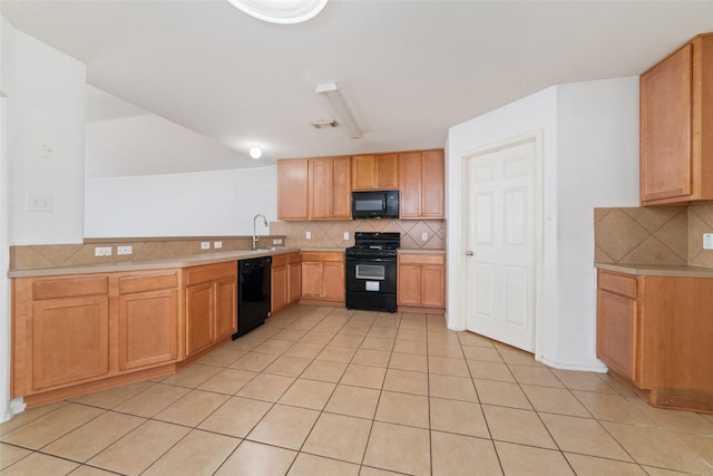 kitchen with light tile patterned floors, a sink, black appliances, light countertops, and tasteful backsplash