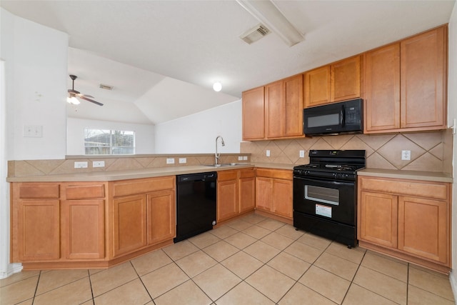 kitchen featuring visible vents, a sink, decorative backsplash, black appliances, and light countertops