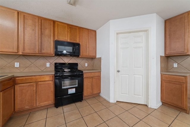 kitchen featuring decorative backsplash, black appliances, light tile patterned floors, and light countertops