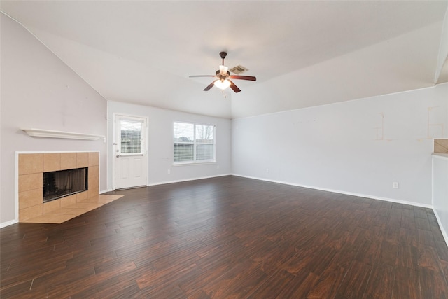 unfurnished living room featuring visible vents, lofted ceiling, dark wood-type flooring, and a tile fireplace