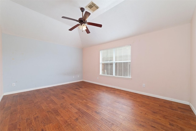 unfurnished room with lofted ceiling, wood finished floors, visible vents, and baseboards