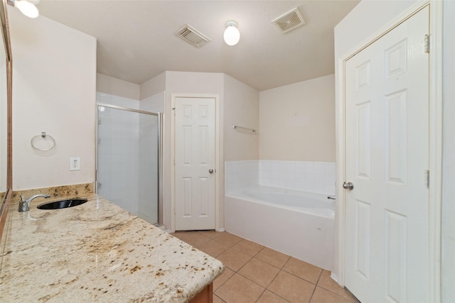 full bathroom featuring tile patterned flooring, visible vents, a stall shower, and a garden tub