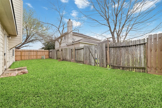 view of yard with a fenced backyard