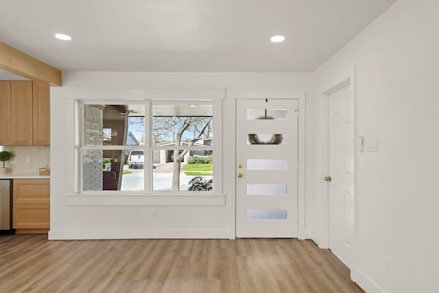 doorway with recessed lighting, baseboards, and light wood-style floors