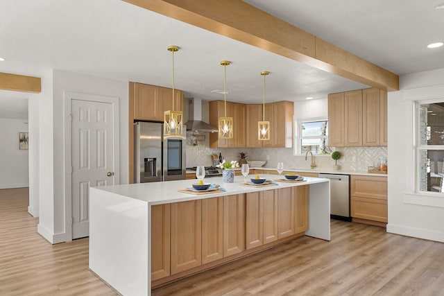 kitchen with tasteful backsplash, light wood-style floors, appliances with stainless steel finishes, wall chimney exhaust hood, and light countertops