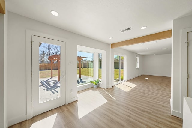 doorway to outside with visible vents, baseboards, beam ceiling, recessed lighting, and light wood-style floors