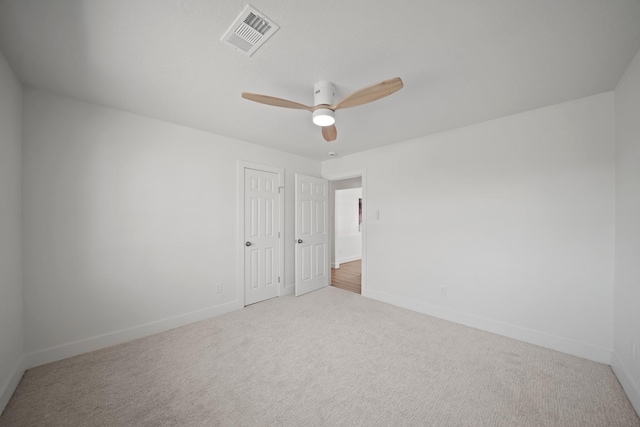 spare room with visible vents, baseboards, and carpet