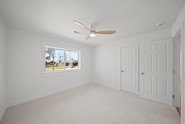 unfurnished bedroom with a ceiling fan, visible vents, carpet, baseboards, and a closet