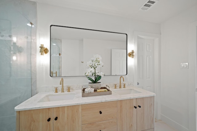 full bathroom featuring double vanity, visible vents, a shower with door, and a sink