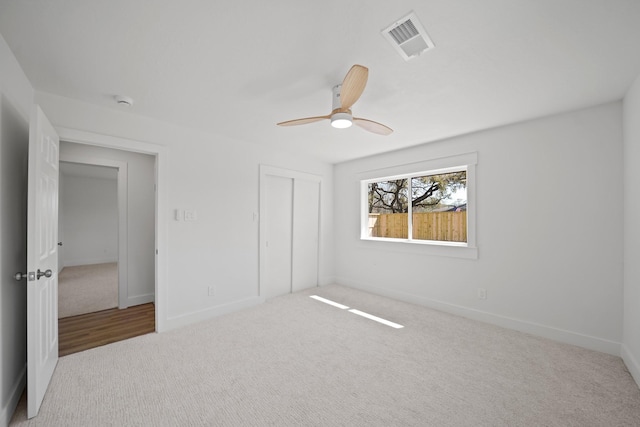 unfurnished bedroom featuring visible vents, a ceiling fan, a closet, carpet flooring, and baseboards