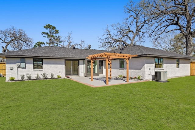 back of house featuring a pergola, fence, a yard, brick siding, and a patio area