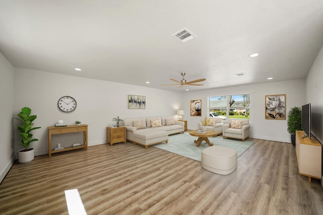 living area featuring recessed lighting, visible vents, baseboards, and wood finished floors