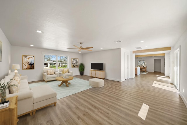 living area with a ceiling fan, visible vents, light wood finished floors, baseboards, and recessed lighting