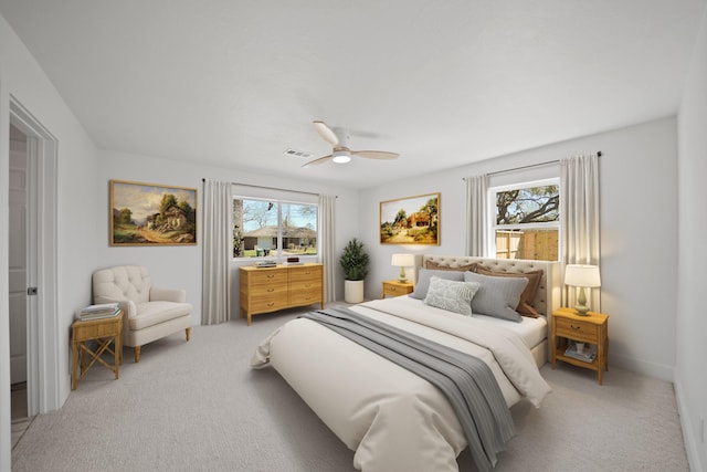 bedroom with visible vents, multiple windows, and light colored carpet