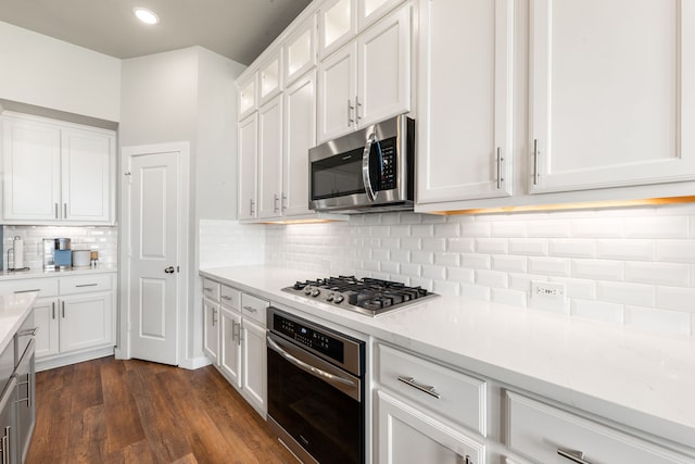 kitchen with dark wood finished floors, white cabinets, glass insert cabinets, and appliances with stainless steel finishes