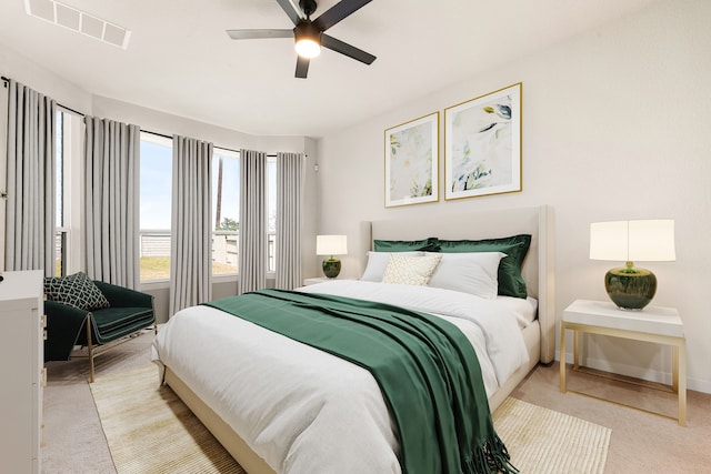 carpeted bedroom featuring visible vents, baseboards, and ceiling fan