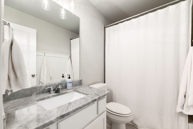 bathroom with toilet and vanity