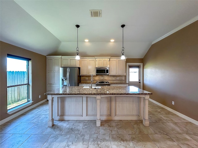 kitchen featuring a kitchen island with sink, visible vents, appliances with stainless steel finishes, and vaulted ceiling