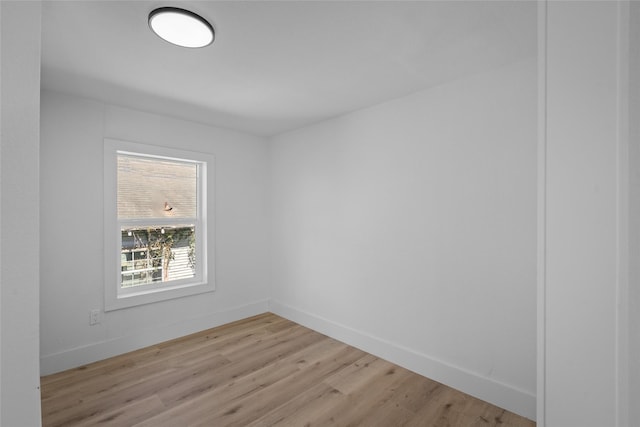 spare room with light wood finished floors and baseboards