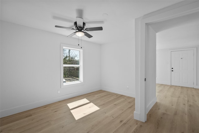 unfurnished room with baseboards, light wood-style floors, and ceiling fan