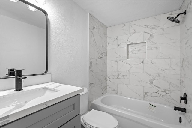 full bathroom featuring shower / bathing tub combination, toilet, vanity, and a textured wall