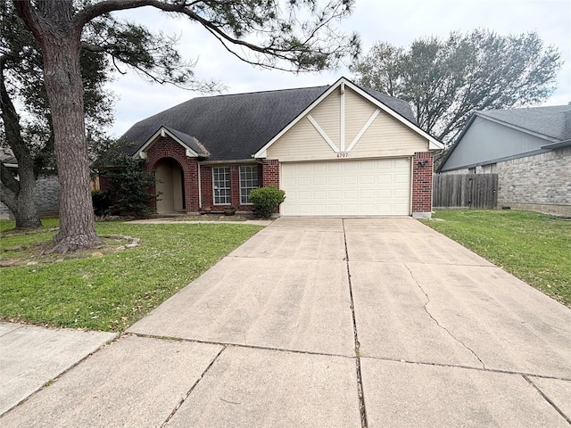 view of front of property featuring brick siding, concrete driveway, a front lawn, and fence