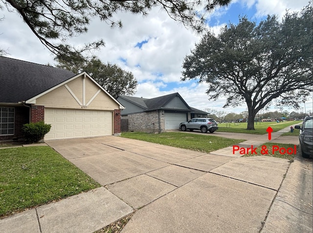 view of front of home featuring concrete driveway, an attached garage, brick siding, and a front yard