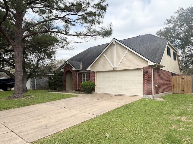 view of front facade with brick siding, an attached garage, concrete driveway, and a front yard