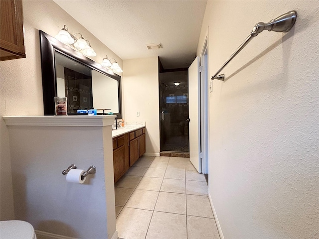 bathroom featuring vanity, visible vents, a stall shower, a textured ceiling, and tile patterned floors