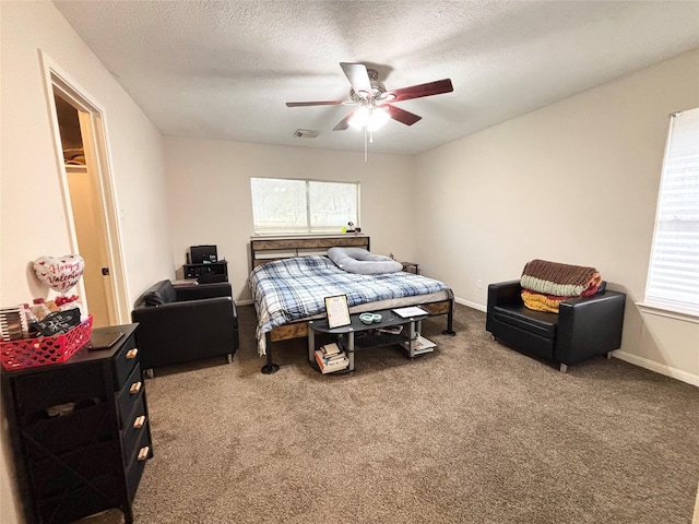 carpeted bedroom with multiple windows, baseboards, visible vents, and a textured ceiling