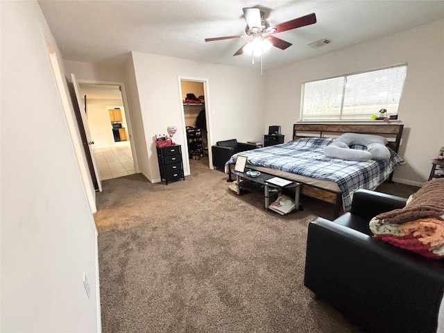 bedroom featuring visible vents, ceiling fan, a spacious closet, a closet, and carpet flooring