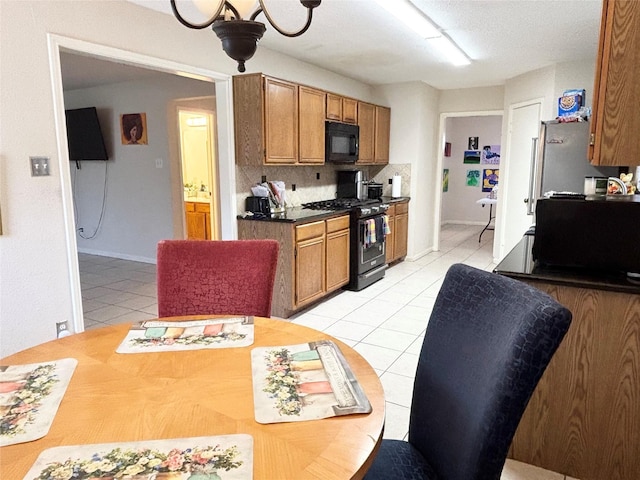 kitchen featuring decorative backsplash, black appliances, light tile patterned floors, and brown cabinets