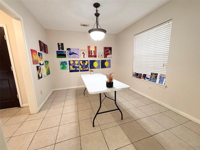 interior space featuring light tile patterned floors, visible vents, and baseboards