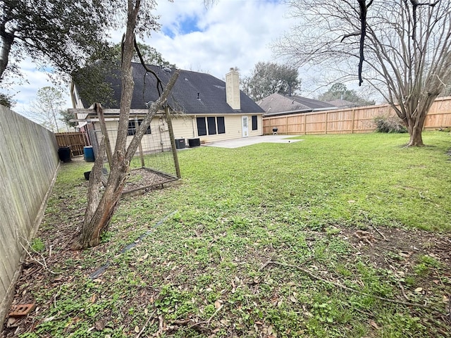 view of yard featuring a patio area and a fenced backyard