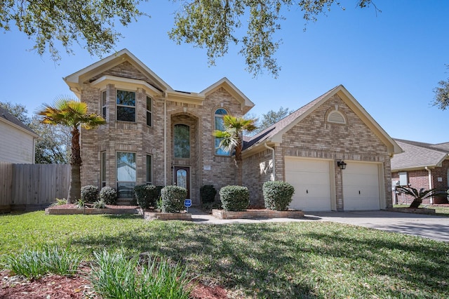 traditional-style house featuring driveway, fence, brick siding, a front lawn, and a garage