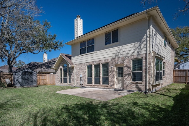back of property with a patio, a chimney, a fenced backyard, brick siding, and an outdoor structure